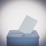 Ballot box and blank paper, studio shot